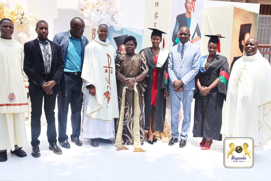  Cossy Baagala celebrates her graduation with family, fellow graduates, Owek. Noah Kiyimba, and Rev. Fr. Robert Mayiga at a ceremony in Lwadda